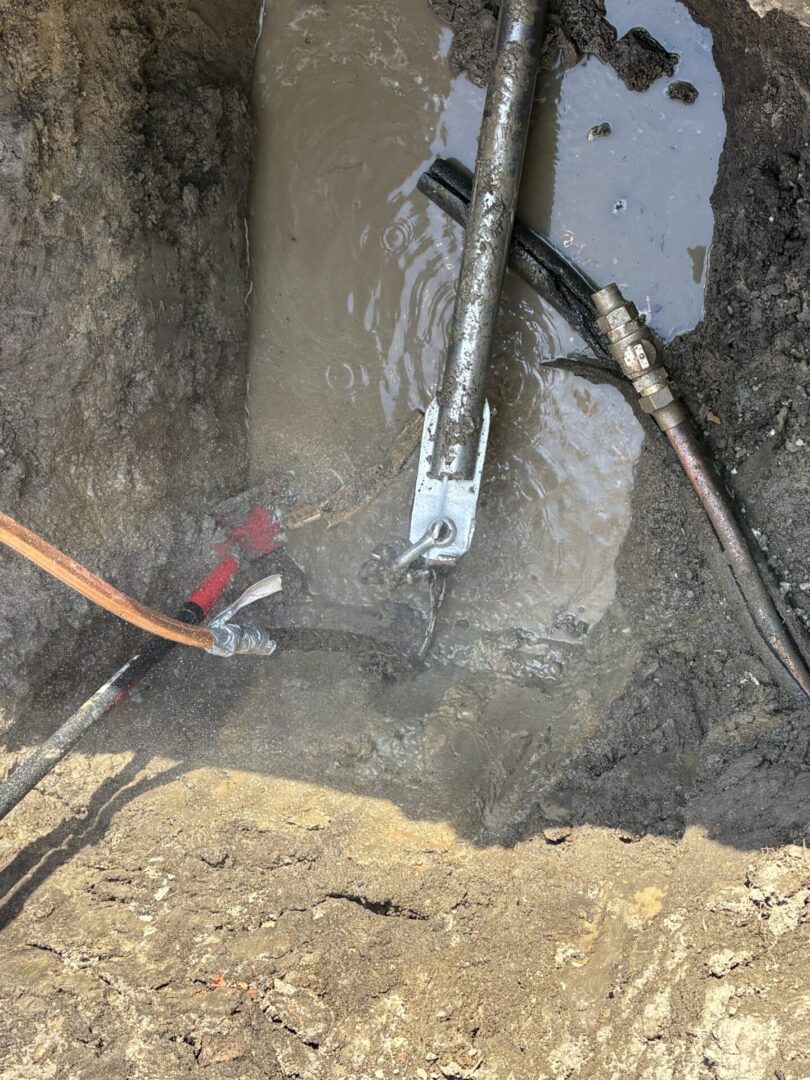 Drilling equipment operating in a muddy outdoor area.