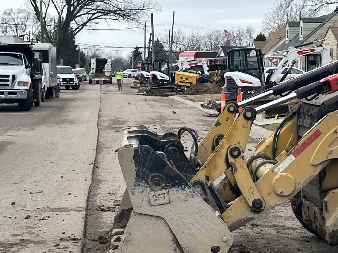Construction equipment working on a street during winter.
