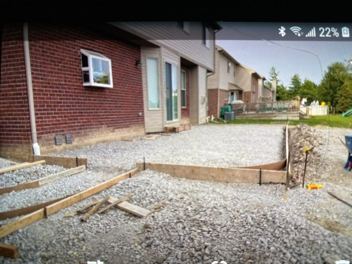 Residential construction site with gravel and wooden frames for concrete.