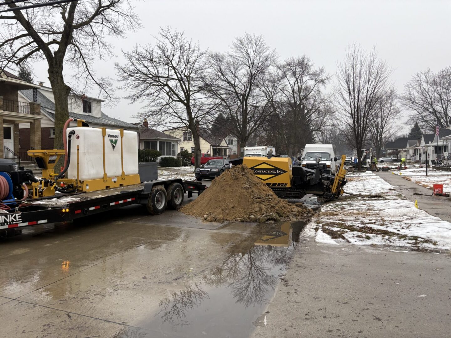 Construction equipment and dirt pile on street