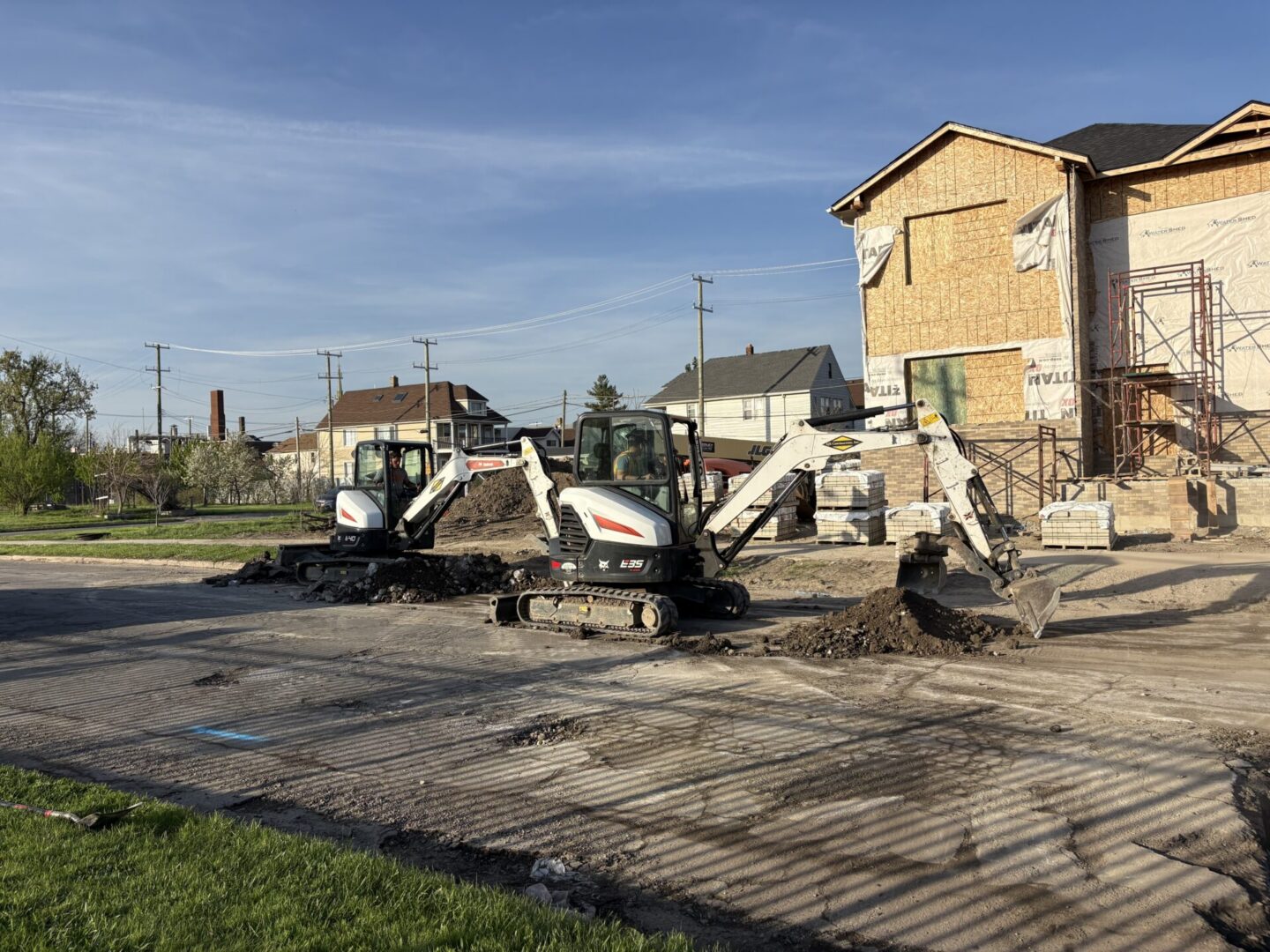 Two mini excavators at residential construction site