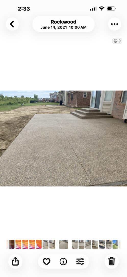 Newly finished concrete driveway and walkway at a residential home.