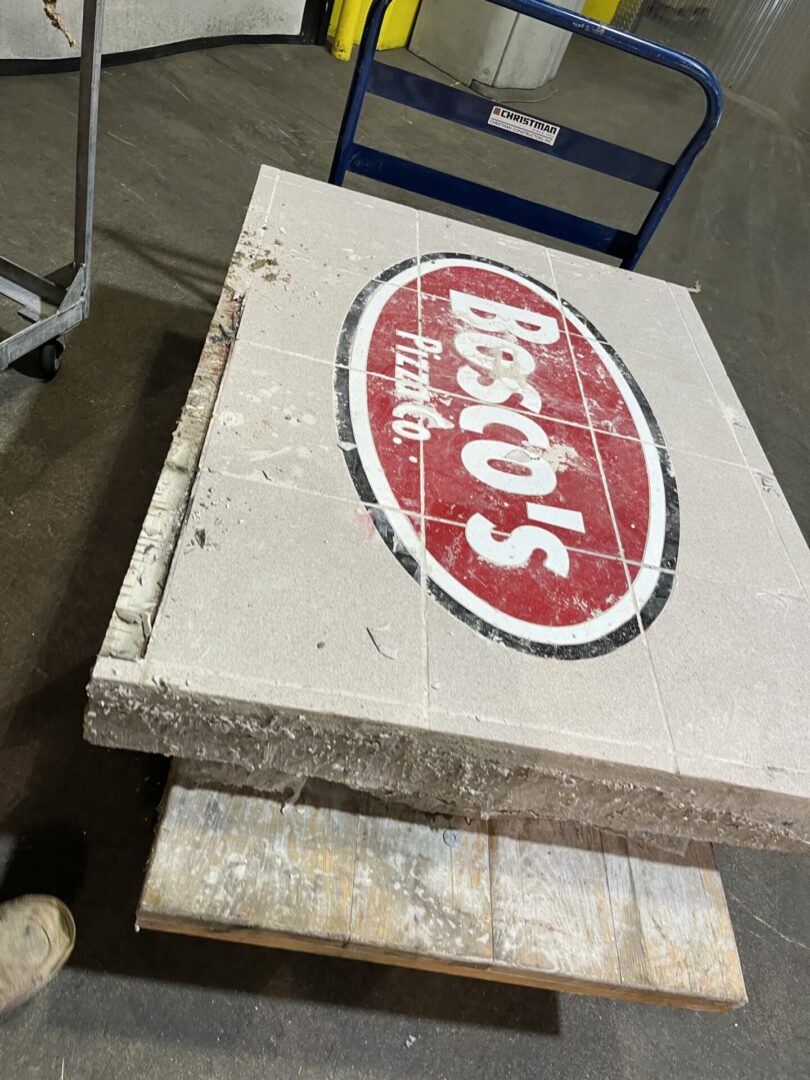 A worn vintage sign for Disko's brand on a wooden board.